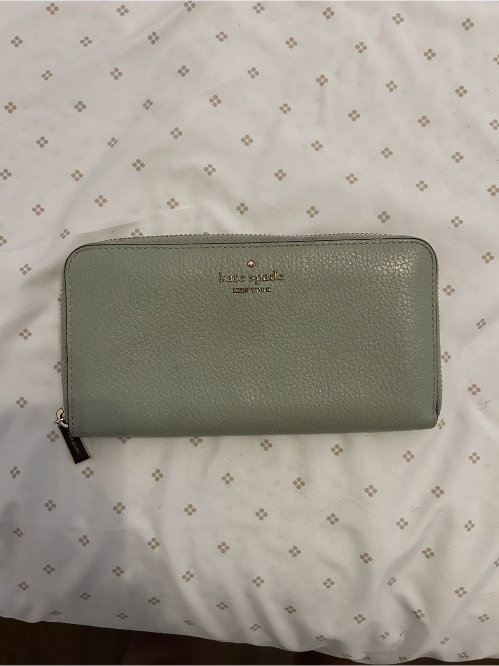 kate spade sage green pebble leather zip wallet with gold logo